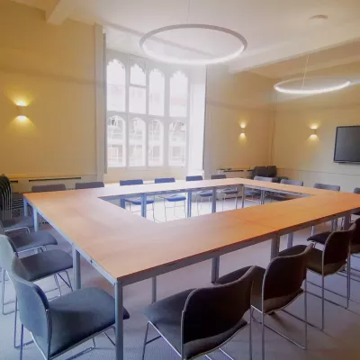 A modern room at Corpus Christi Cambridge with smart TV, which can seat up to 20 delegates.
