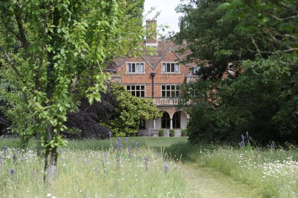 View of the back of Leckhampton House from the prairie garden
