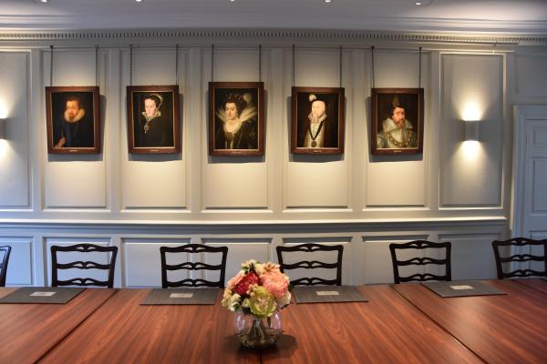 Showing the wood paneled wall with portraits in the Parker Room, Corpus Christi College Cambridge.